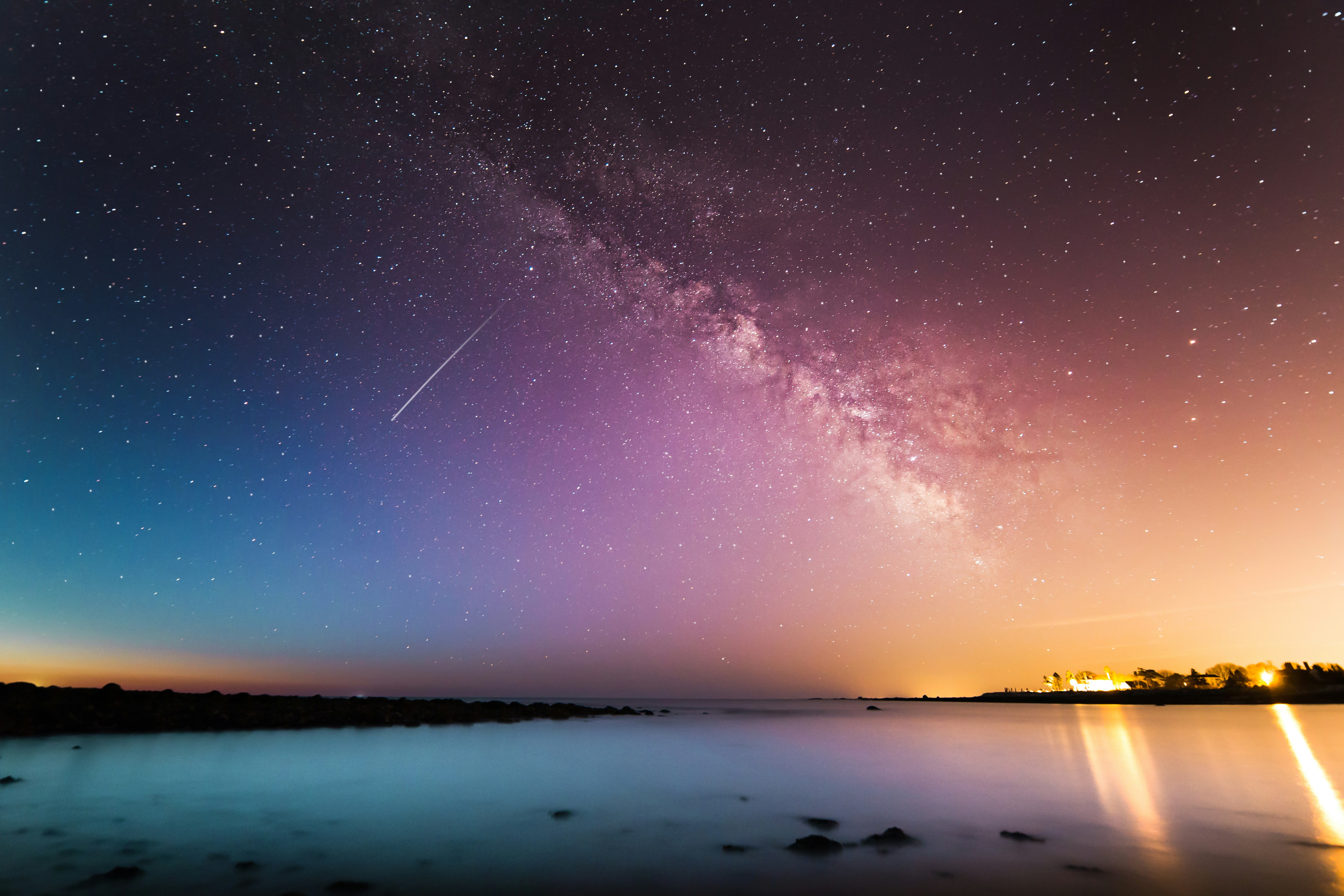 milky way above body of water